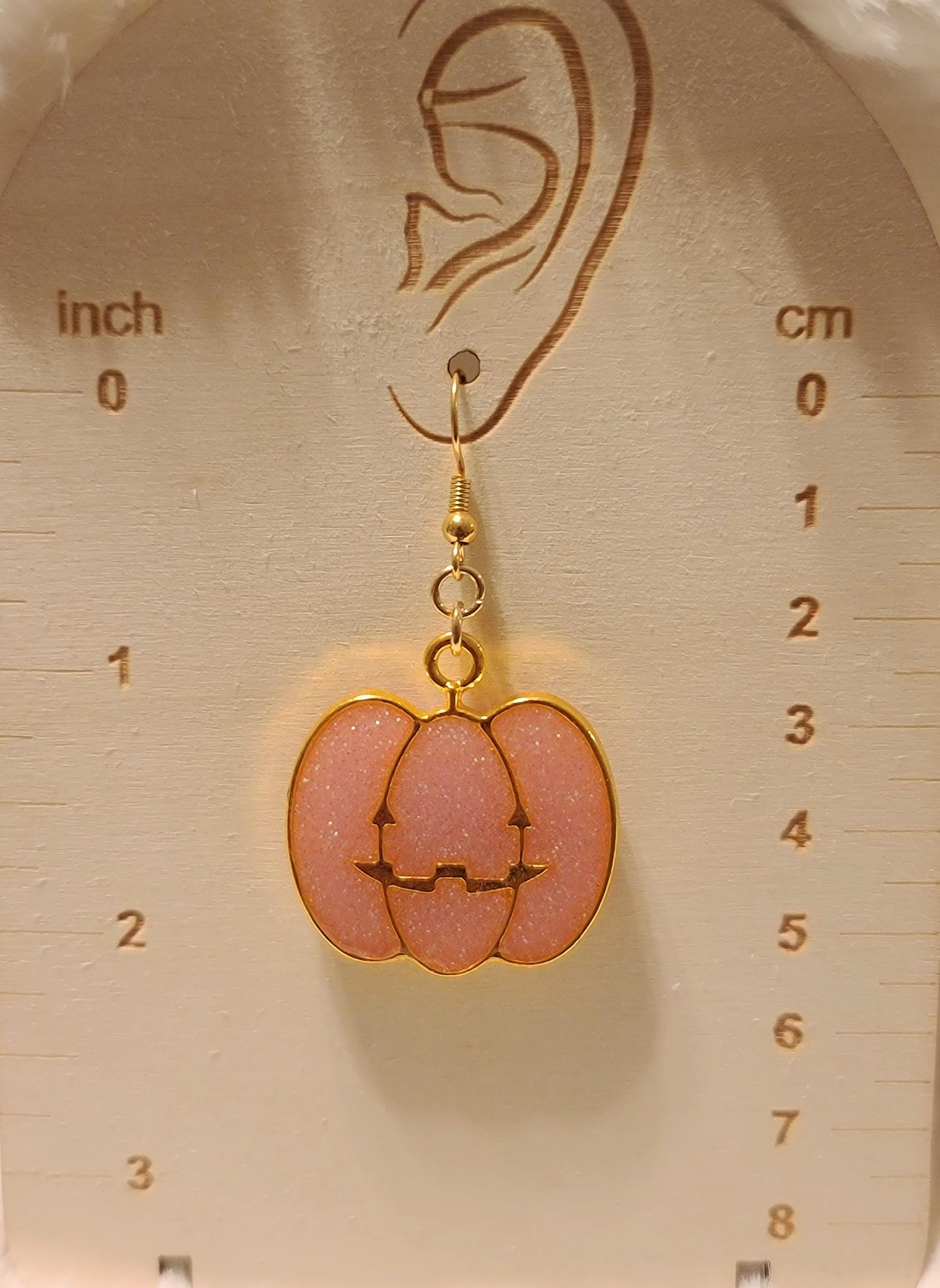Pink pumpkin face earrings